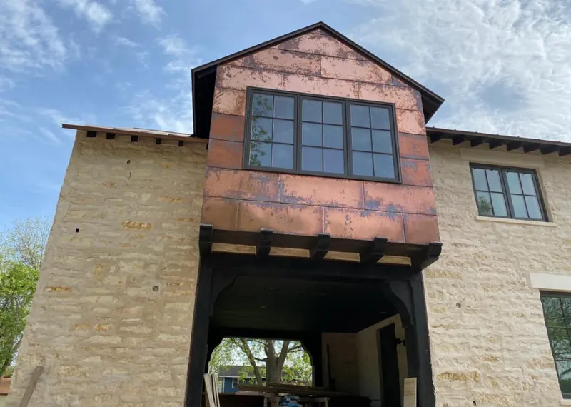 Copper metal panel facade on a stone building for Skylight Installation in Olivette