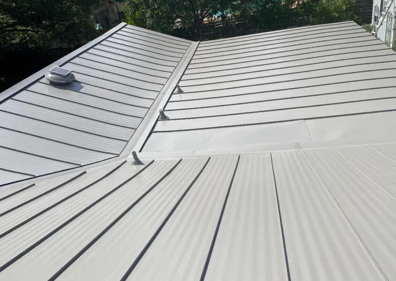 Solar attic fan installed on a metal roof for Roof Ventilation in Olivette